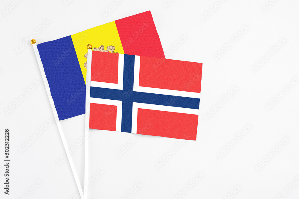 Norway and Andorra stick flags on white background. High quality fabric, miniature national flag. Peaceful global concept.White floor for copy space.