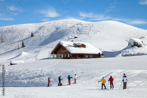 Skiers on mountain slope in Italian Dolomites