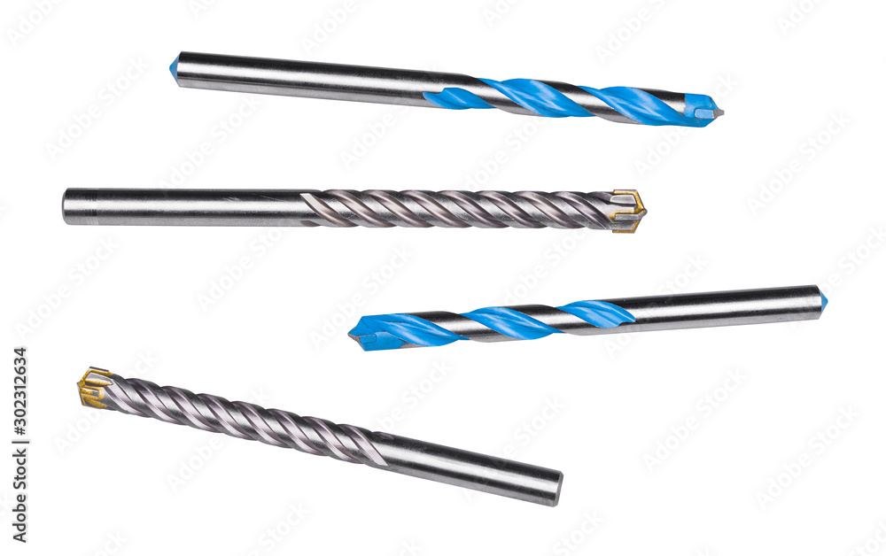 Drill bits for drilling masonry, stone or concrete isolated on white background. Set of steel spiral fluted cutters with cemented carbide cutting edges or blue surface finishing. Silvery metal tools. Drill bits for drilling masonry, stone or concrete isolated on white background. Set of steel spiral fluted cutters with cemented carbide cutting edges or blue surface finishing. Silvery metal tools.