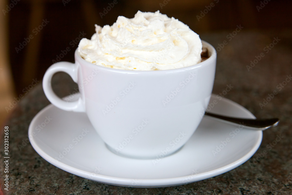 Cup of hot chocolate with whipped cream and a piece of cake Cup of hot chocolate with whipped cream and a piece of cake