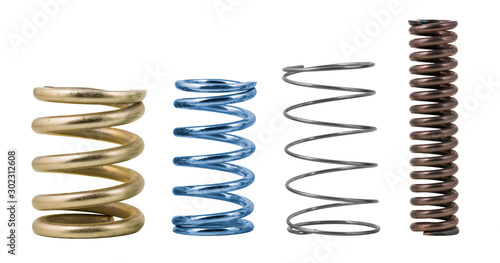 Four steel compression coil springs with varied surface finish isolated on white background. Springy metallic machine parts. Set of different flexible elastic shock absorbers with spiral wire winding. photo