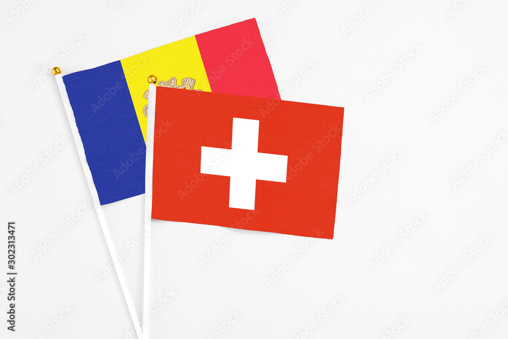Switzerland and Andorra stick flags on white background. High quality fabric, miniature national flag. Peaceful global concept.White floor for copy space.