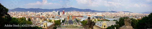 Panoramic of Barcelona with the towers in the Plaza Espana, the bullring, the ancient sculptures and the mountains in the background