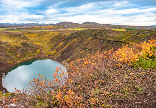 Volcanic crater Kerid with blue lake inside, at autumn day, Iceland Gold Circle tourist attraction. photo