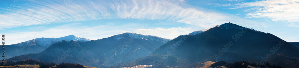 panorama of mountains with snow capped tops above the rural valley. wonderful weather condition of november. borzhava ridge with Velykyy Verkh, Play and Temnatyk peaks