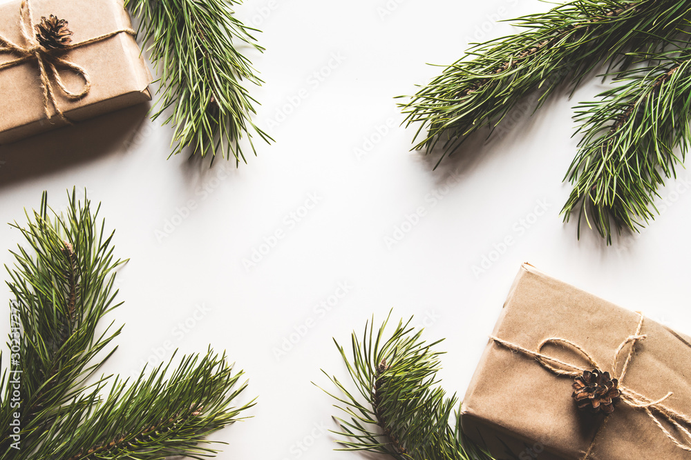 Gift box with christmas green framework and pine cones on white background. Copy space and Top view Gift box with christmas green framework and pine cones on white background. Copy space and Top view