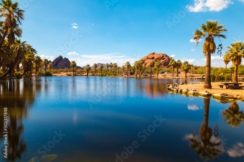Serene, tranquil scenery of Papago park, one of the famous places in Phoenix Arizona. Bright, colorful and a beautiful day with blue sky and clear water surface. 