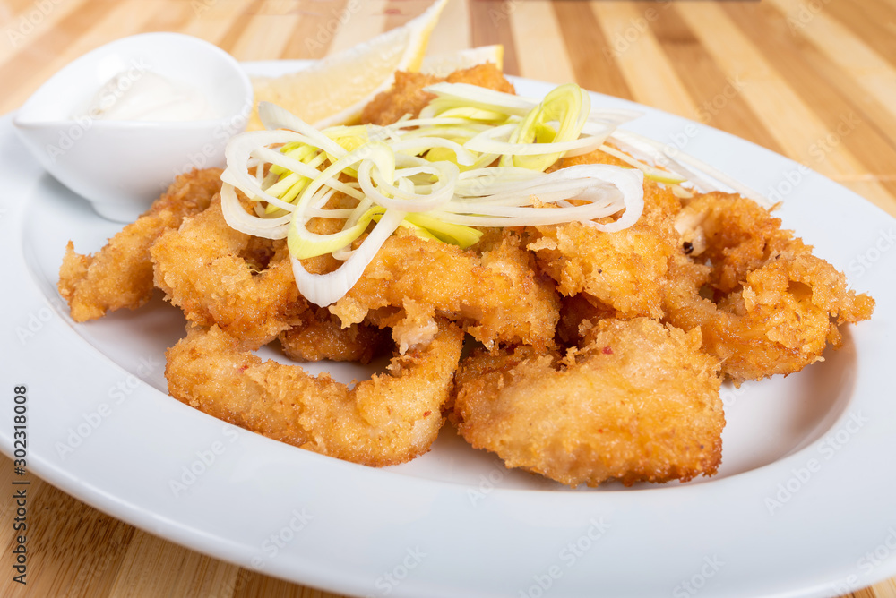 Grilled squid rings, with lemon and sauce. Grilled squid rings, with lemon and sauce.