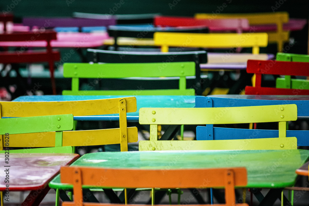 detail of very colorful chairs and tables near a cafe in the Montmartre district, Paris, France