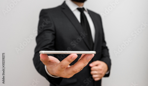 Male human wear formal work suit hold smart hi tech smartphone use one hand