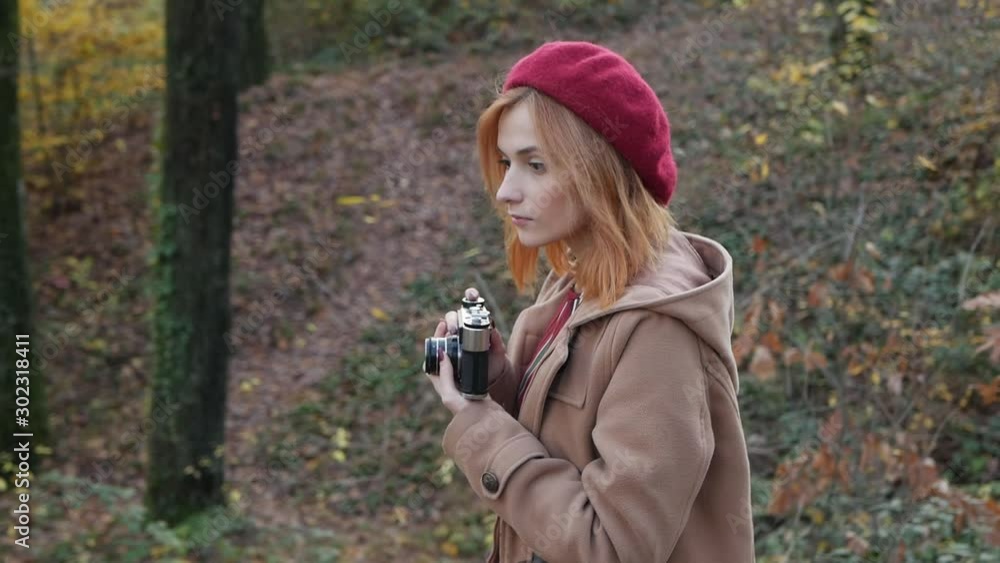 Girl shows emotions of joy in the forest in a red beret Girl shows emotions of joy in the forest in a red beret