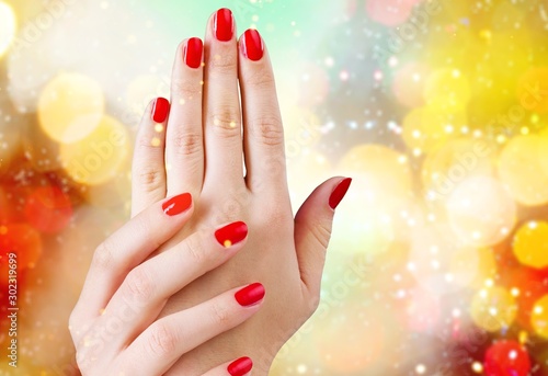 Young beautiful woman hands with red manicure