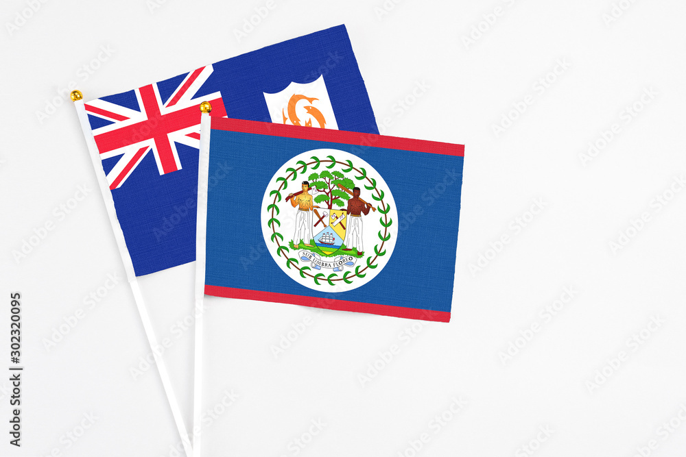 Fototapeta premium Belize and Anguilla stick flags on white background. High quality fabric, miniature national flag. Peaceful global concept.White floor for copy space.
