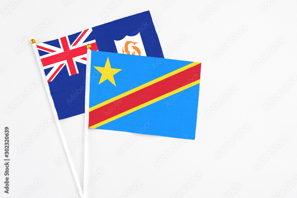 Fototapeta premium Congo and Anguilla stick flags on white background. High quality fabric, miniature national flag. Peaceful global concept.White floor for copy space.