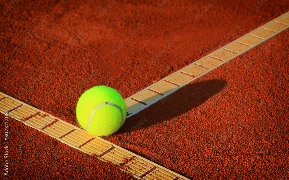 Tennis balls on a tennis clay court