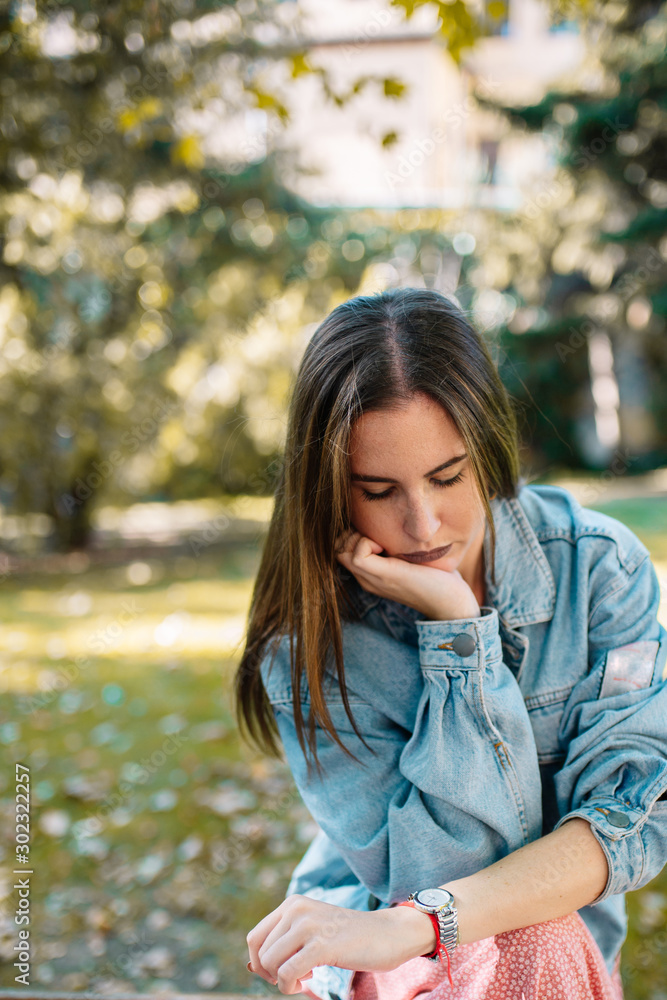 Closeup portrait of stressed young woman looking her wristwatch Closeup portrait of stressed young woman looking her wristwatch
