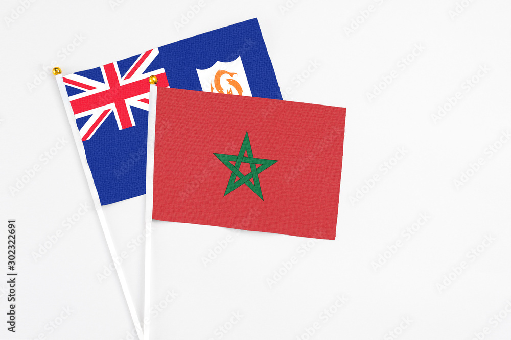 Morocco and Anguilla stick flags on white background. High quality fabric, miniature national flag. Peaceful global concept.White floor for copy space. Morocco and Anguilla stick flags on white background. High quality fabric, miniature national flag. Peaceful global concept.White floor for copy space.