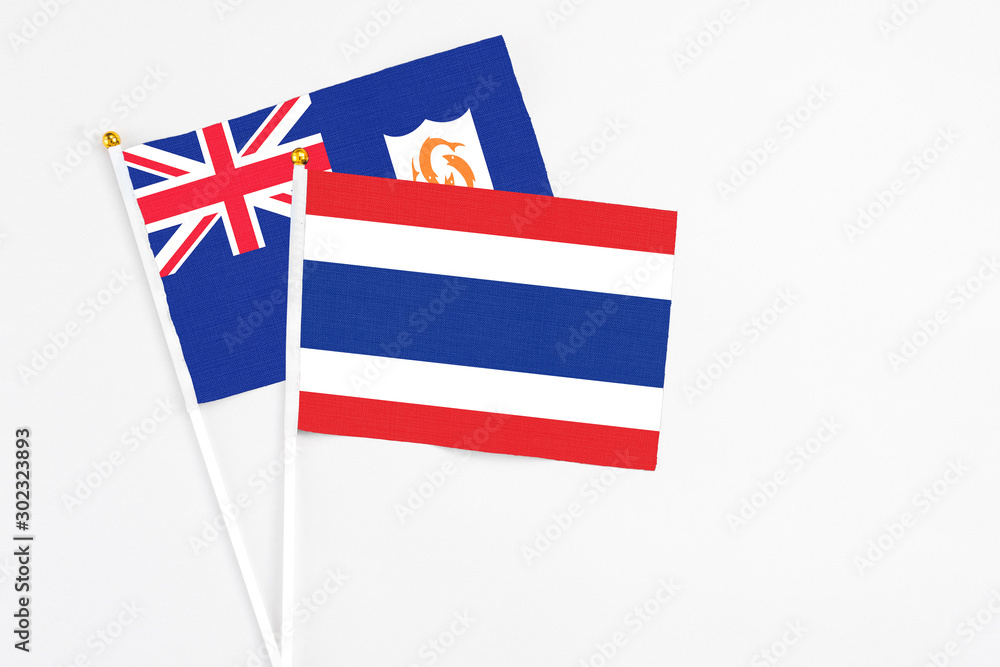 Thailand and Anguilla stick flags on white background. High quality fabric, miniature national flag. Peaceful global concept.White floor for copy space. Thailand and Anguilla stick flags on white background. High quality fabric, miniature national flag. Peaceful global concept.White floor for copy space.