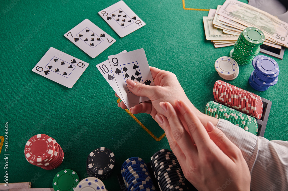 The player opens a straight flush on the background of a poker table, chips, and money. Casino. Victory The player opens a straight flush on the background of a poker table, chips, and money. Casino. Victory
