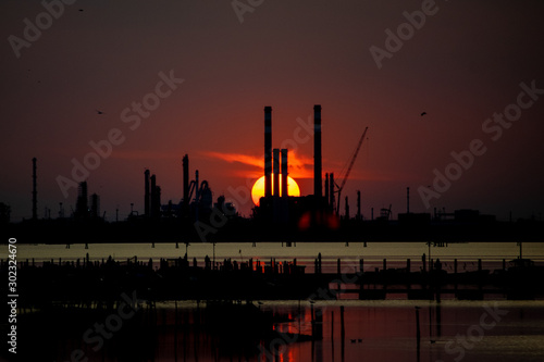 oil refinery at sunset