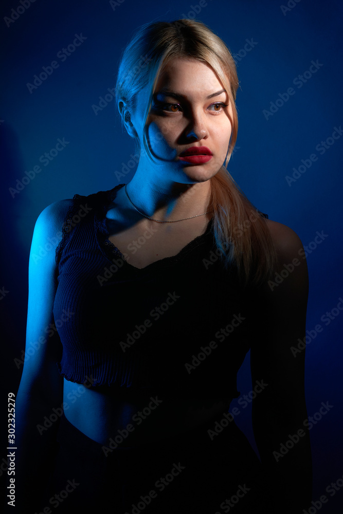 portrait of a beautiful girl with red lips on a blue background portrait of a beautiful girl with red lips on a blue background