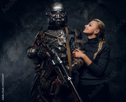 Happy smiling woman is posing for photographer with dark apocalypse warrior.