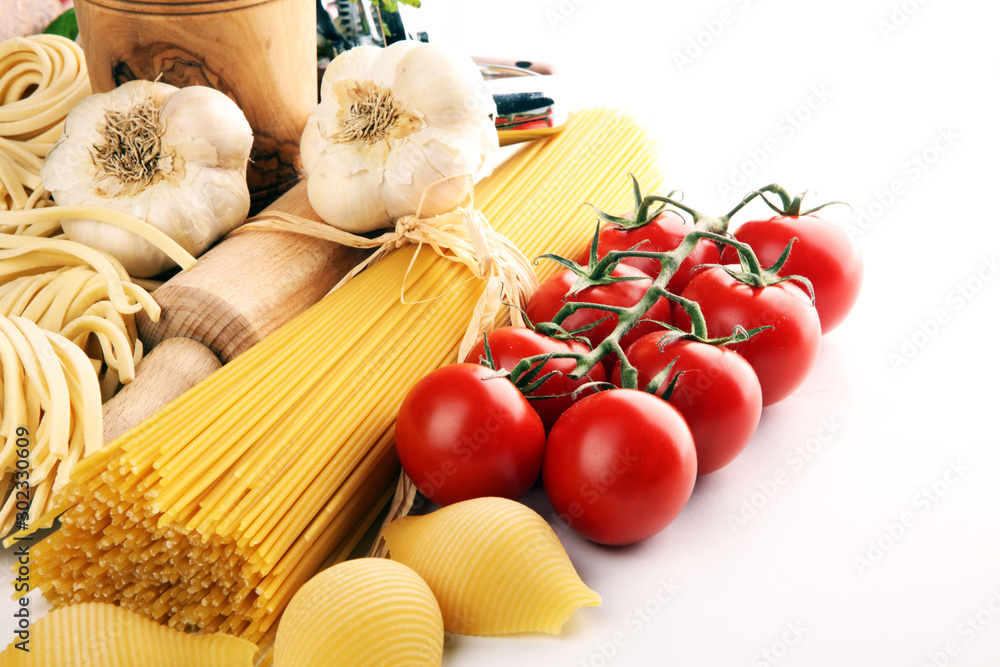 Pasta, vegetables, herbs and spices for Italian food on rustic table Pasta, vegetables, herbs and spices for Italian food on rustic table