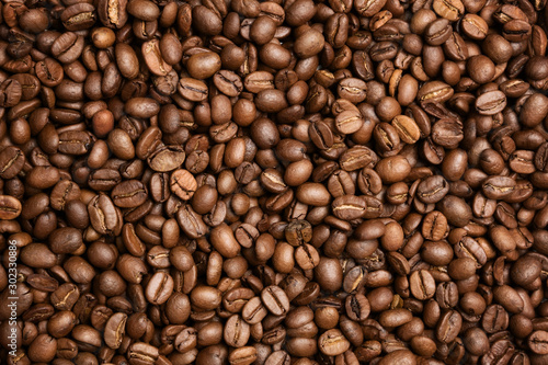 Flat lay photo of dark roasted coffe beans pile
