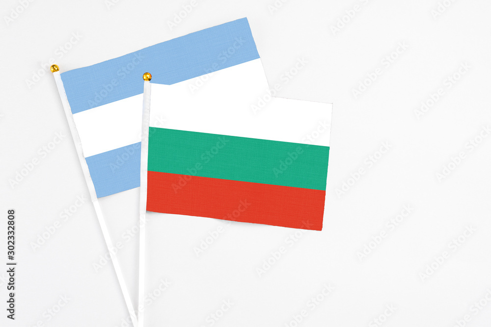 Bulgaria and Argentina stick flags on white background. High quality fabric, miniature national flag. Peaceful global concept.White floor for copy space. Bulgaria and Argentina stick flags on white background. High quality fabric, miniature national flag. Peaceful global concept.White floor for copy space.