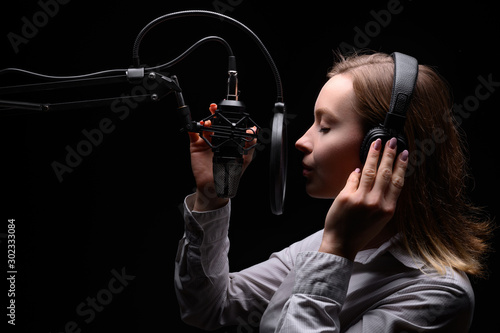 Singer, blogger, voice acting. Work in the studio with a studio microphone. photo