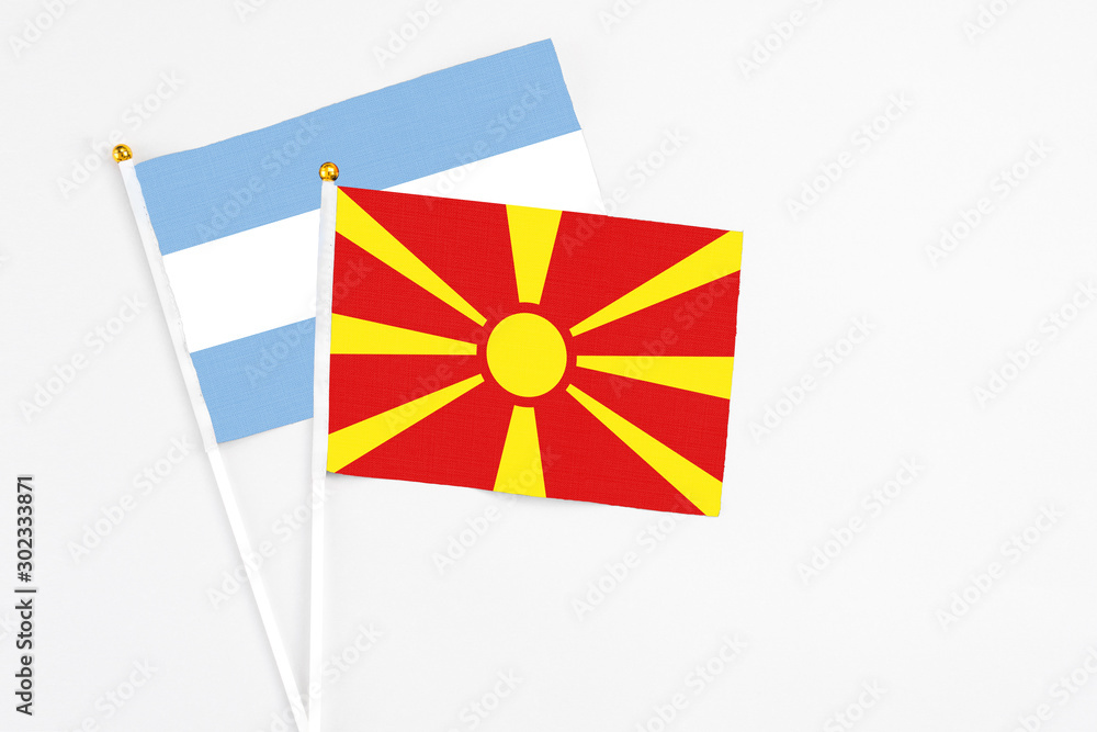 Macedonia and Argentina stick flags on white background. High quality fabric, miniature national flag. Peaceful global concept.White floor for copy space.