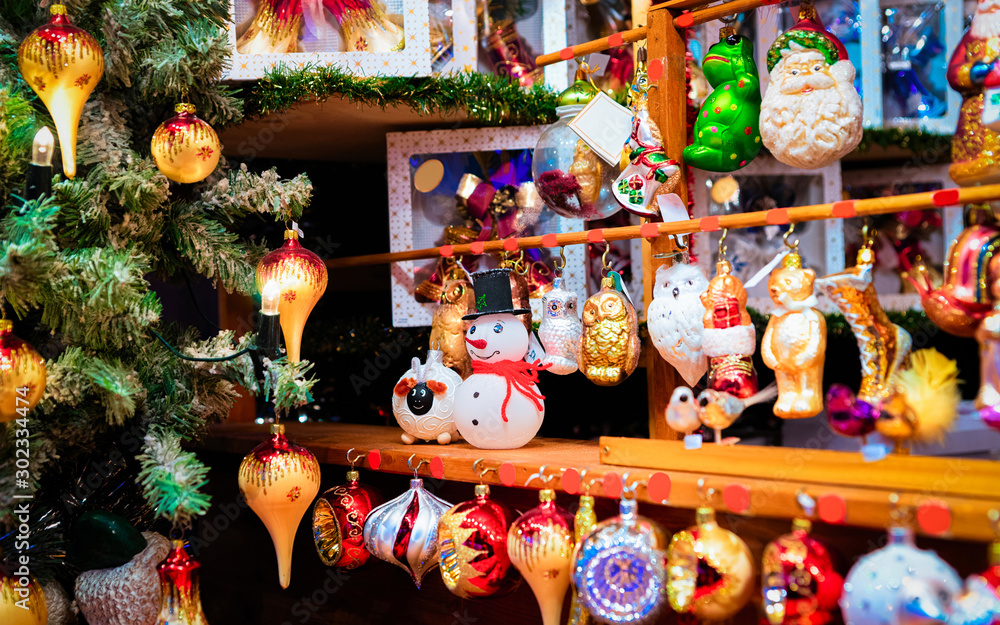 Glass Christmas tree decorations of Christmas market at Germany in Europe in winter. German Night street Xmas and holiday fair in European city or town, December. Berlin in Alexanderplatz. Glass