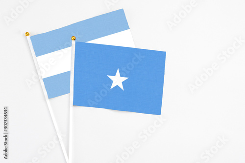 Free Download Somalia and Argentina stick flags on white background. High quality fabric, miniature national flag. Peaceful global concept.White floor for copy space. - GFXLoad