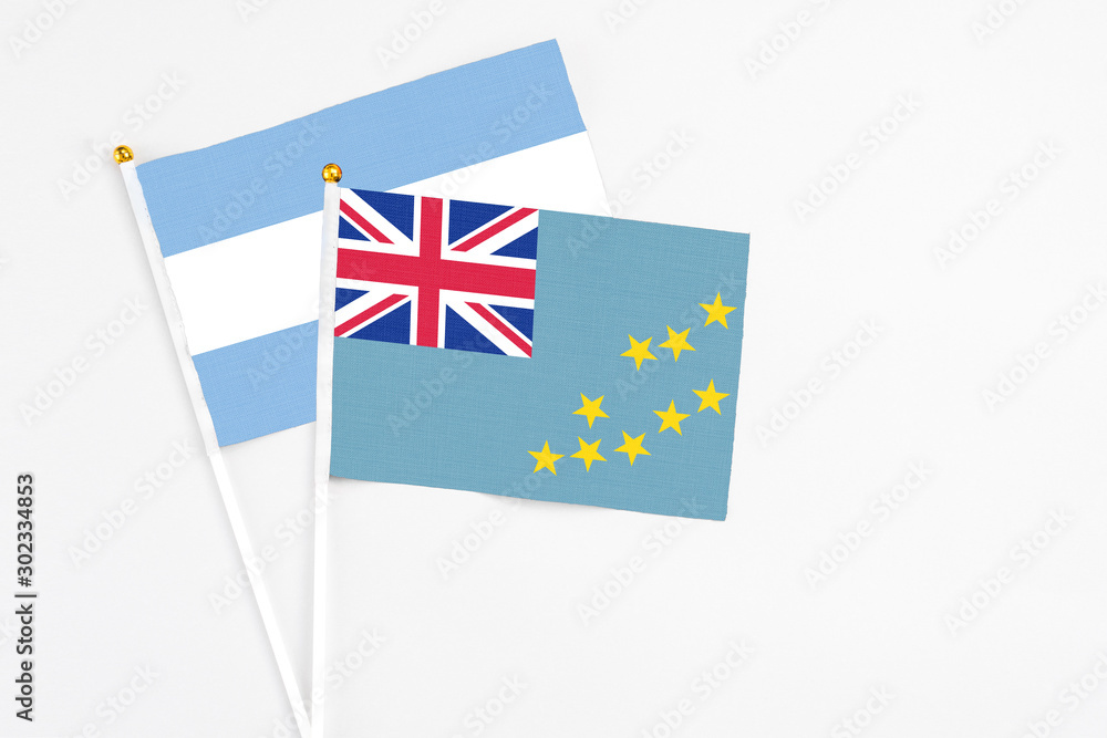 Tuvalu and Argentina stick flags on white background. High quality fabric, miniature national flag. Peaceful global concept.White floor for copy space. Tuvalu and Argentina stick flags on white background. High quality fabric, miniature national flag. Peaceful global concept.White floor for copy space.