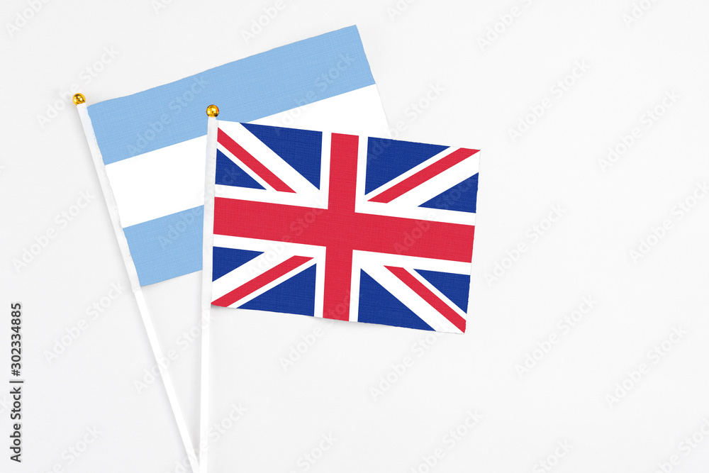 United Kingdom and Argentina stick flags on white background. High quality fabric, miniature national flag. Peaceful global concept.White floor for copy space. United Kingdom and Argentina stick flags on white background. High quality fabric, miniature national flag. Peaceful global concept.White floor for copy space.