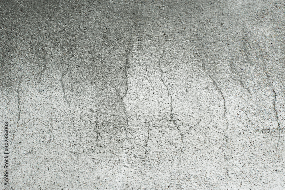 Cement wall texture with cracked and rough surfaces.