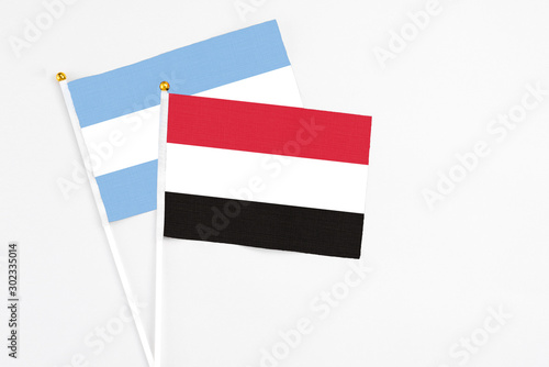 Free Download Yemen and Argentina stick flags on white background. High quality fabric, miniature national flag. Peaceful global concept.White floor for copy space. - GFXLoad