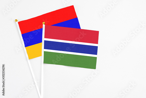 Gambia and Armenia stick flags on white background. High quality fabric  miniature national flag. Peaceful global concept.White floor for copy space.