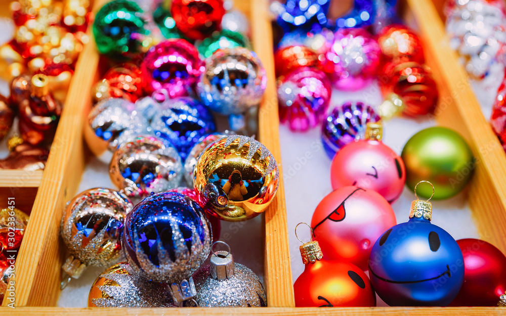 Fototapeta premium Christmas tree decorations in Christmas Market at Town Hall in Winter Berlin, Germany. Advent Fair and Stalls with Crafts Items on the Bazaar. Glass