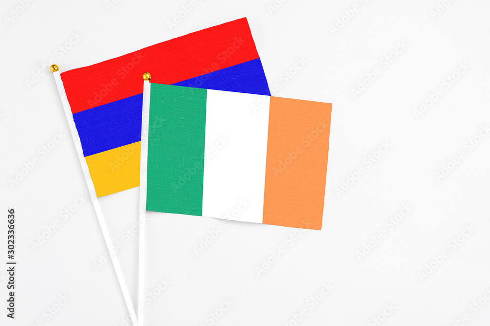 Ireland and Armenia stick flags on white background. High quality fabric, miniature national flag. Peaceful global concept.White floor for copy space. Ireland and Armenia stick flags on white background. High quality fabric, miniature national flag. Peaceful global concept.White floor for copy space.