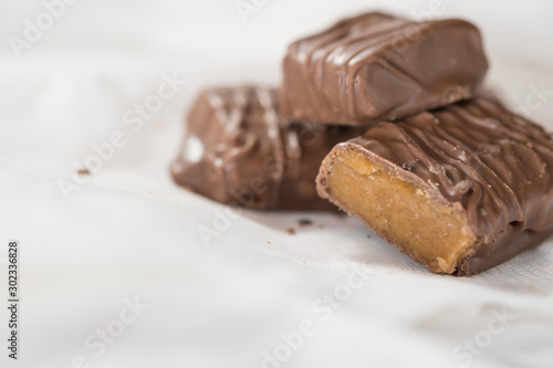 CHOCOLATE BARS WITH TOFFEE CARAMEL ON WHITE NAPKIN  COPY SPACE 