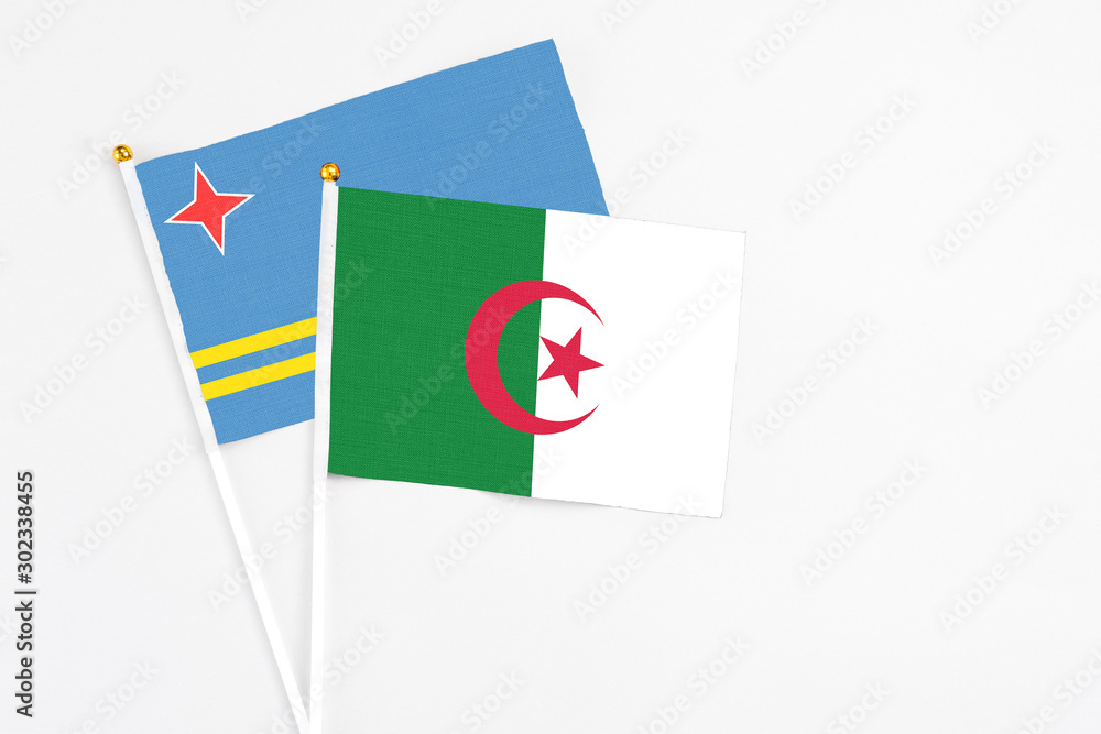 Algeria and Aruba stick flags on white background. High quality fabric, miniature national flag. Peaceful global concept.White floor for copy space. Algeria and Aruba stick flags on white background. High quality fabric, miniature national flag. Peaceful global concept.White floor for copy space.