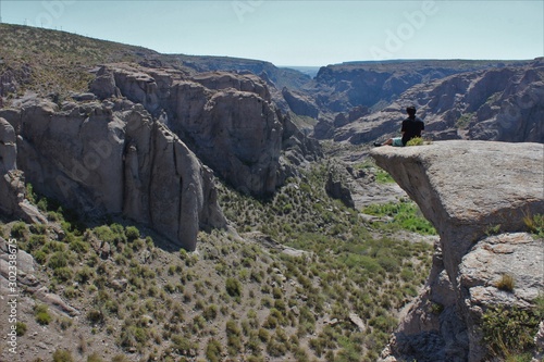 A man sitting on the edge of the cliff in Atuel Canyon, Mendoza, Argentina