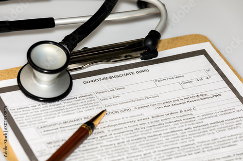 DNR, do not resuscitate, advanced directive medical form with stethoscope and ball point pen. Concept of planning end of life and healthcare wishes