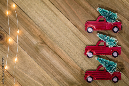 Christmas Holiday Winter still life concept on wooden board with vintage red truck and tree decor, flat lay room for text copy