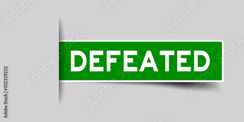 Label sticker green color in word defeated that inserted in gray background
