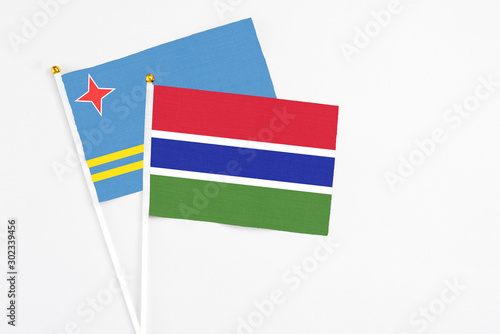 Free Download Gambia and Aruba stick flags on white background. High quality fabric, miniature national flag. Peaceful global concept.White floor for copy space. - GFXLoad