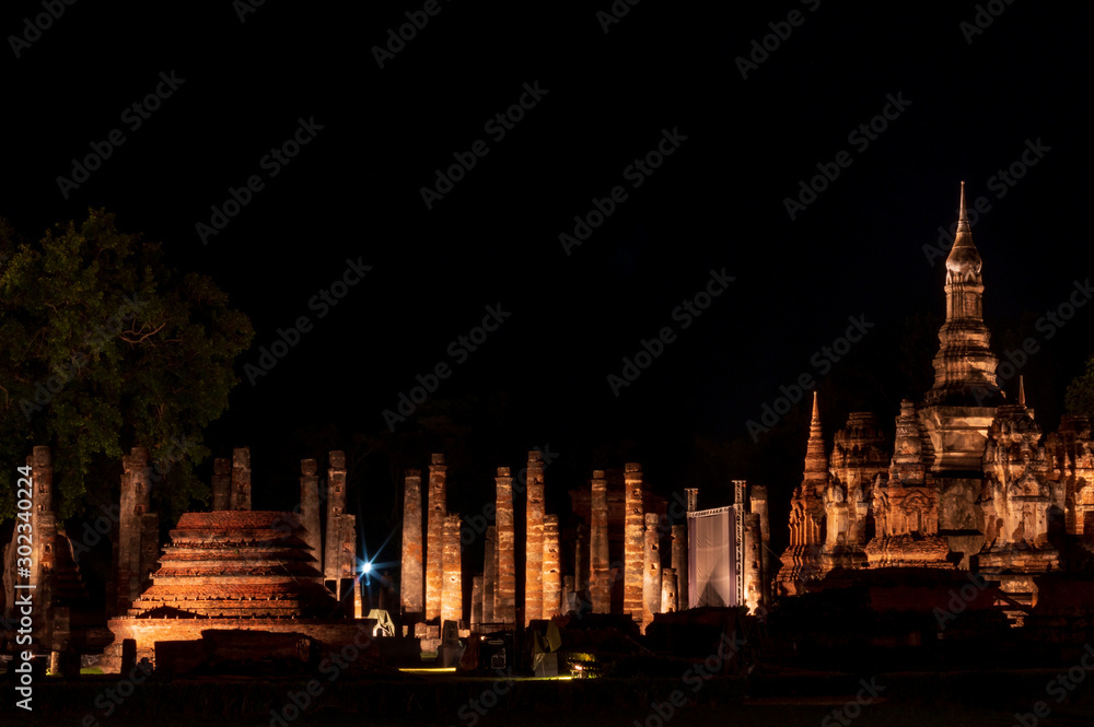 Fotografie Old Buddhist temple with light in the dark.
