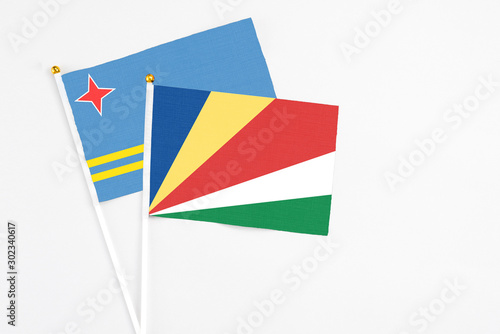 Seychelles and Aruba stick flags on white background. High quality fabric, miniature national flag. Peaceful global concept.White floor for copy space. Free Download Seychelles and Aruba stick flags on white background. High quality fabric, miniature national flag. Peaceful global concept.White floor for copy space. - GFXLoad