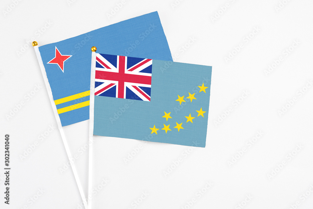 Tuvalu and Aruba stick flags on white background. High quality fabric, miniature national flag. Peaceful global concept.White floor for copy space. Tuvalu and Aruba stick flags on white background. High quality fabric, miniature national flag. Peaceful global concept.White floor for copy space.
